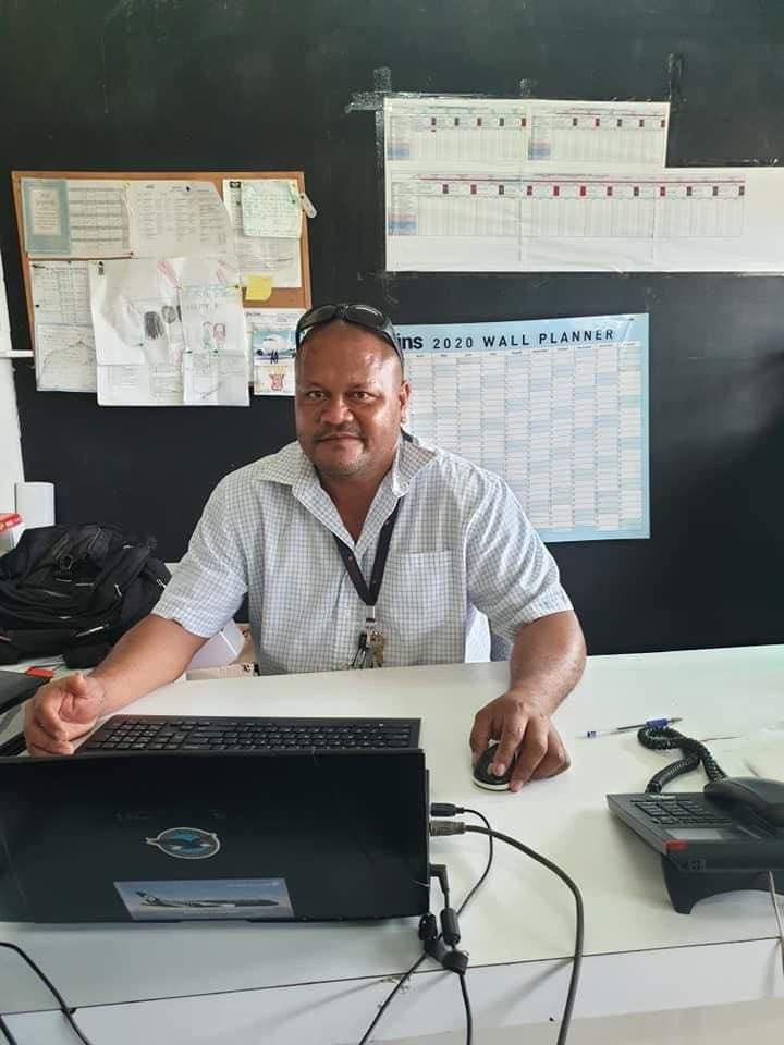 Aisake Manu Chief engineer for Palu aviation company seated at his desk.