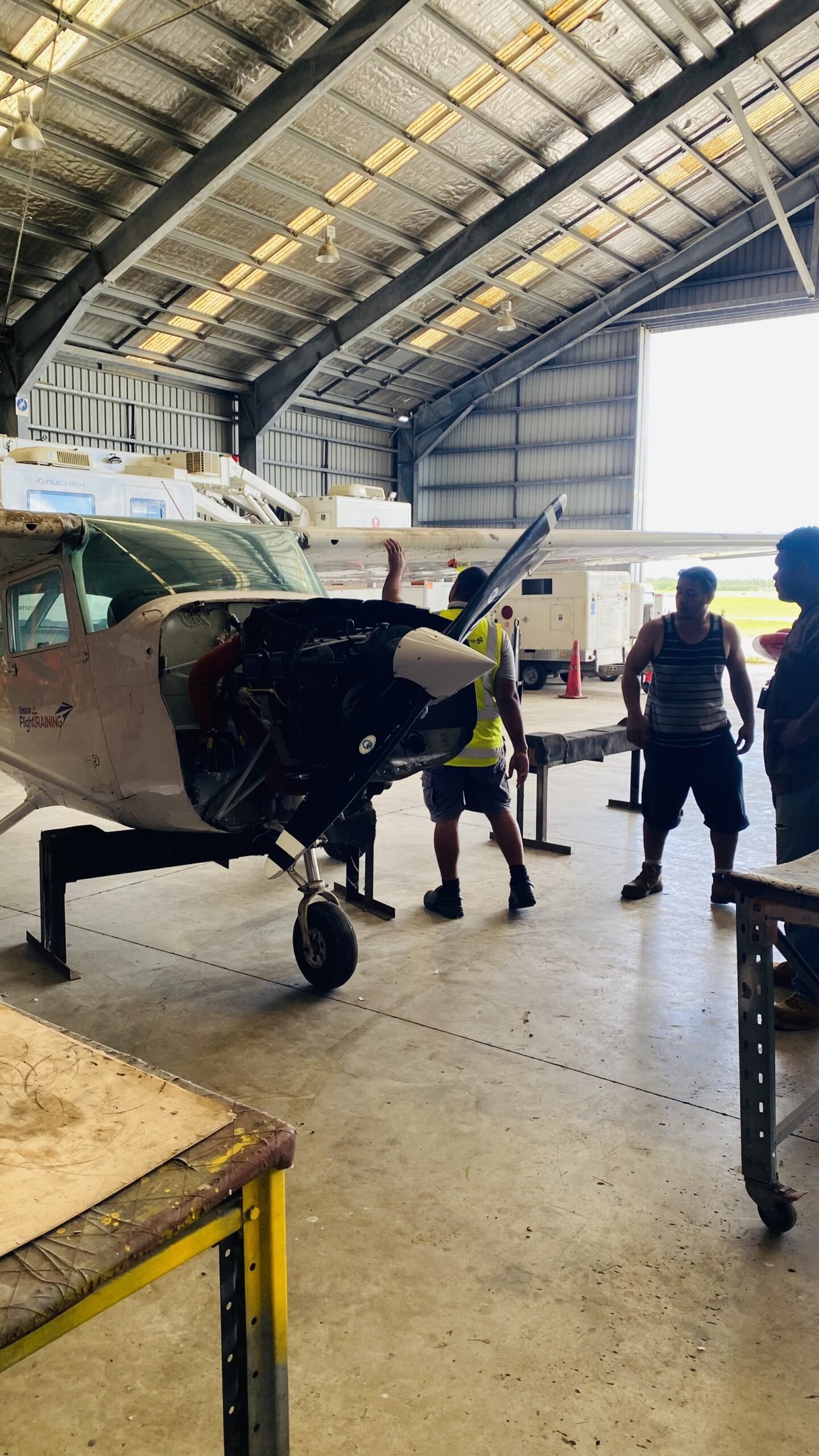 PAS Engineers looking at small aircraft at hangar