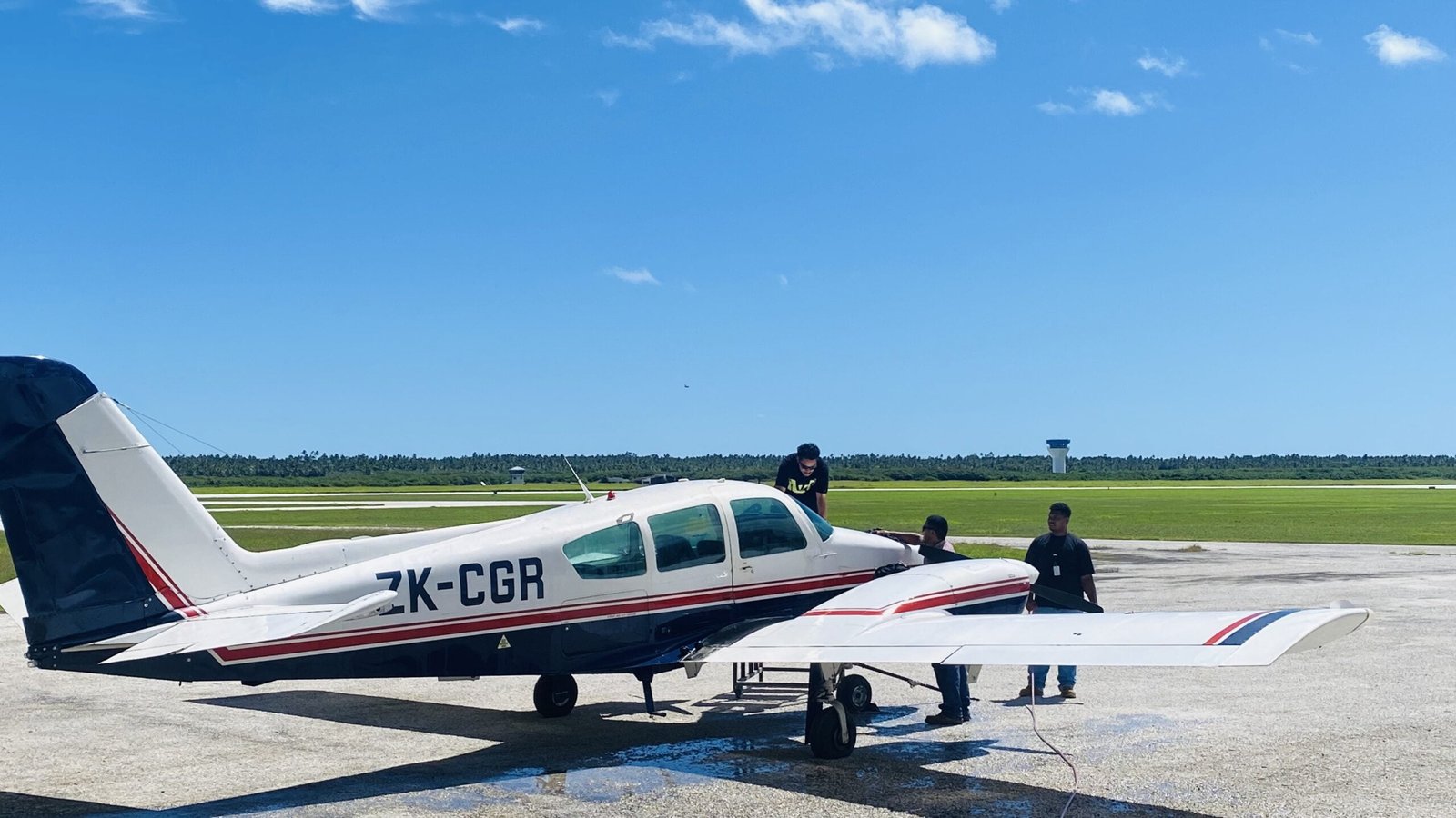 small aircraft with PAS aircraft engineers on the runway.