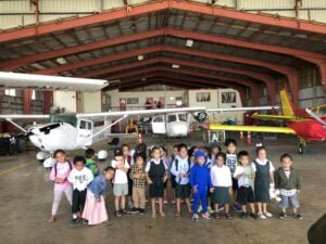 Kids posing infront of aircraft